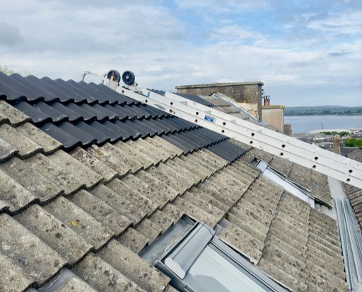 image of a ladder on a roof overlooking the sea